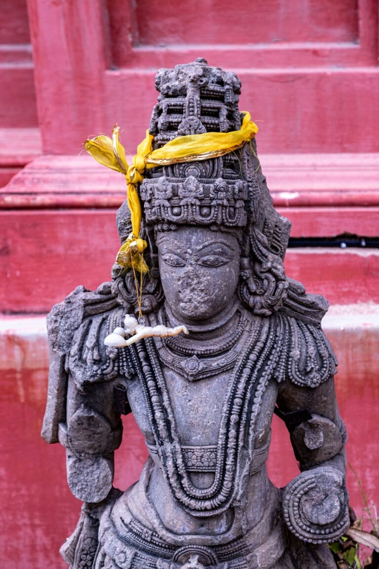 a statue of a person with a yellow ribbon around their head